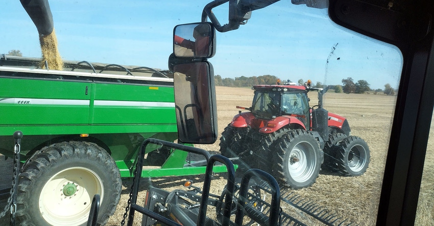 Combine unloading into grain cart Combine unloading into grain cart