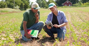 farmer and consultant in soybean field