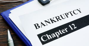 Paper says "Chapter 12 bankruptcy" on clipboard