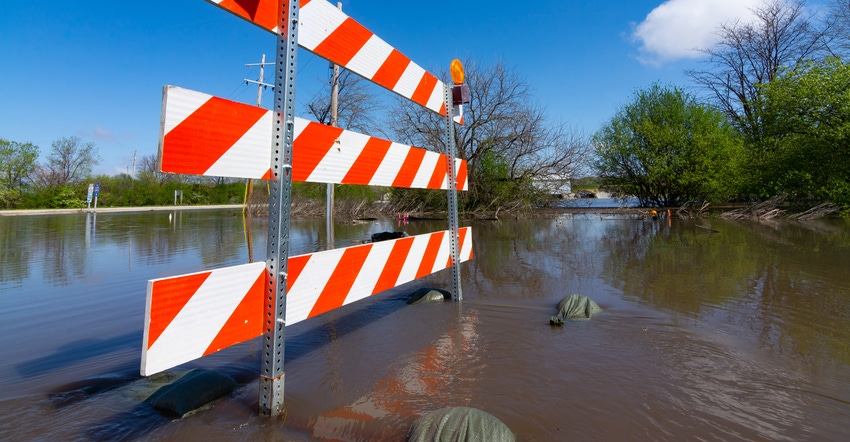 Partially submerged road closure sign