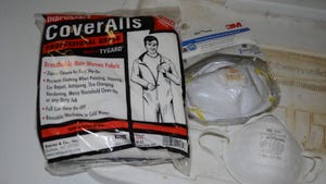 package containing protective coveralls and valved respirator mask
