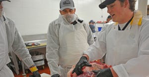 Clay Newton, explains to Peyton Bahe and other team members the best way to get the most and best cuts out of a hindquarter 