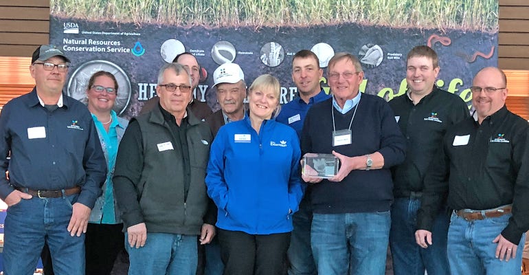 Dwayne Beck (holding plaque) and Ruth Beck receive Friend of Soil Health award