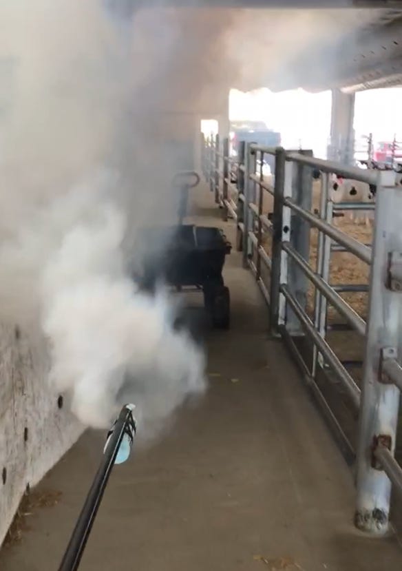 Smoke sticks are used to fog a barn to check the ventilation system