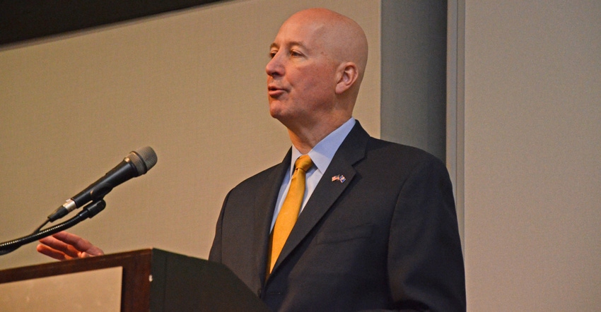 Gov. Pete Ricketts talking at a podium