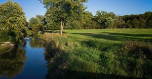  Farmland stream and pasture having undergone streambank restoration and stabilization on a warm sunny autumn day.