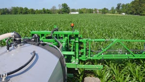View from inside a sprayer cab in a cornfield