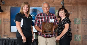 Holly Spangler presents Dale Hadden and wife Amy the Master Farmer award