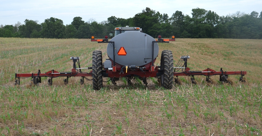 farm equipment applying fertilizer in field