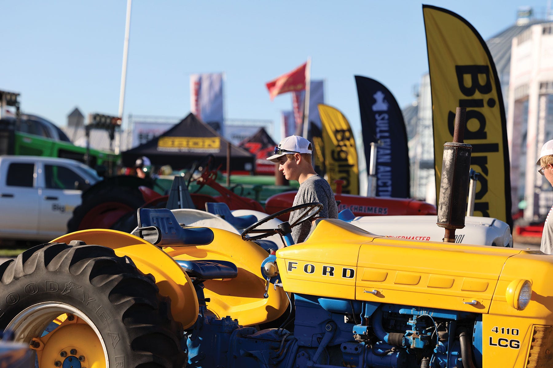 yellow Ford tractor on a lot at a farm show yellow Ford tractor on a lot at a farm show