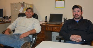 Bryan and Chris Harnish relax in their farm office