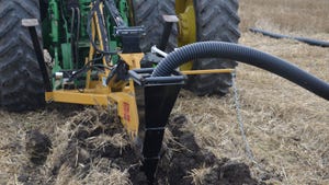 close-up of equipment putting in ag tile