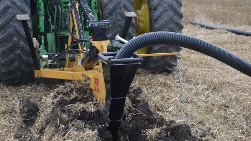 close-up of equipment putting in ag tile close-up of equipment putting in ag tile