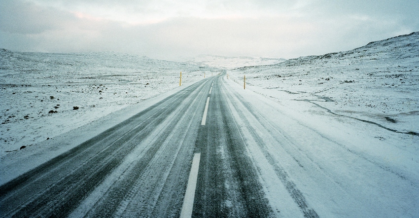 Frozen, snow covered road in rural area