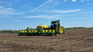 John Deere planter and tractor in field