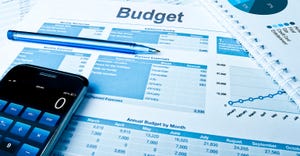 calculator, pen and budget sheets