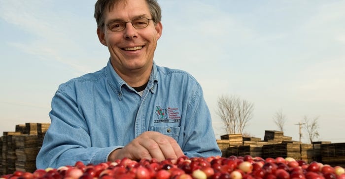 A man holding cranberries