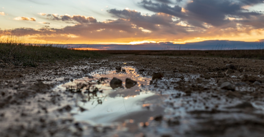 sunset setting over wet prairie 