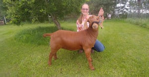 McKenzie Shelden poses with her Boar goat. 