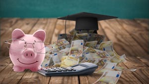 Piggy bank with money, calculator and black graduation cap