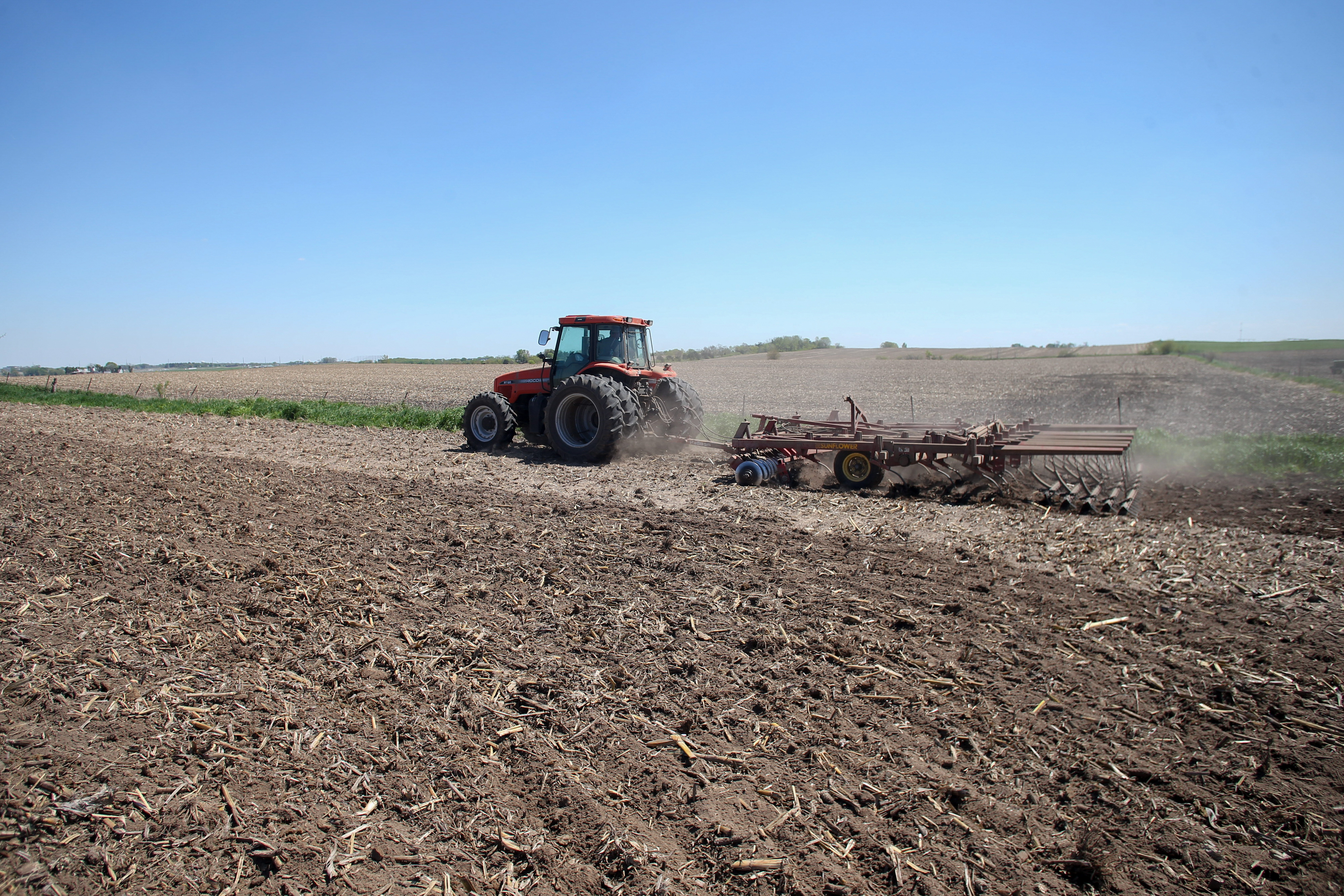 A tractor tills the soil at a farm in Tiffin, Iowa, in 2025.