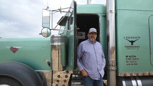 Jeff Landrum, Lineville, Iowa standing next to a truck that hauls grain