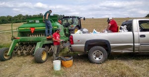 Workers prepare to plant cover crops