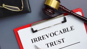 Gavel next to a clipboard with irrevocable trust document