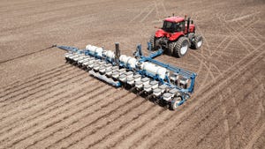 aerial view of a tractor planting a cornfield