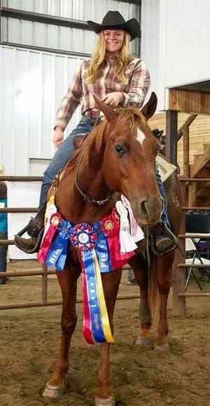  Brook Staten on her sorrel gelding, Jericho with award ribbons around the hourses neck