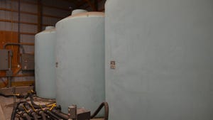 Three large cylinder storage containers for liquid fertilizer