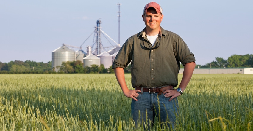 young farmer standing in field