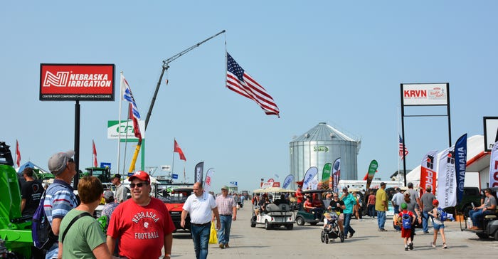 Visitors at 2022 Husker Harvest Days with flag lined street Visitors at 2022 Husker Harvest Days with flag lined street