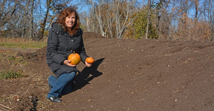 Noreen Thomas holding small pumpkins