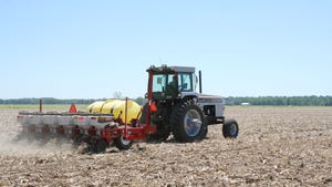 A tractor planting seeds in a field