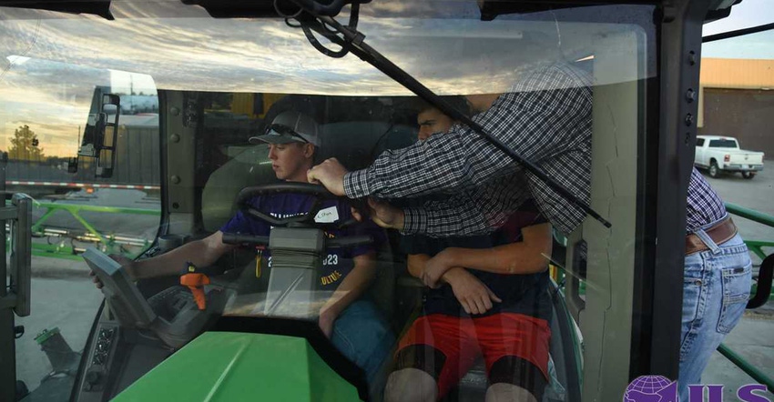 Garret Smith  and students inside a John Deere Sprayer 