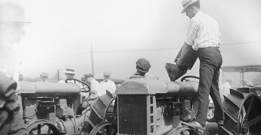 A farmer fills his tractor with kerosene in this 1925 photo. 