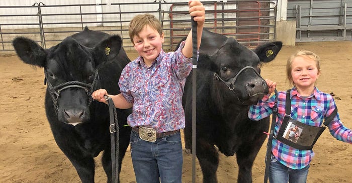Nolan and Maliyah Goehring with cattle