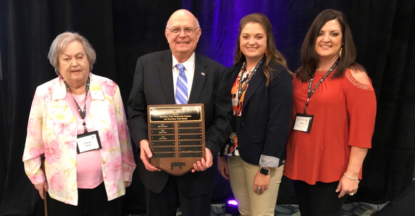 Sam Hines was honored with the Paulson-Whitmore State Executive Award at the National Pork Industry Forum in Orlando. Family 
