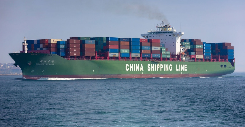 A Chinese bulk ship carries stacks of shipping containers
