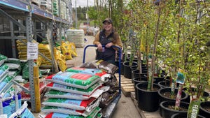 Sarah McNaughton in garden center with bags of mulch