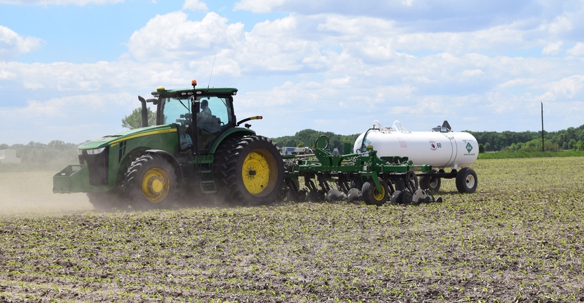 Farmer spraying field