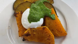 A roasted squash dish with yogurt, walnuts and a spiced green sauce