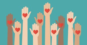 A group of raised hands holds up hearts