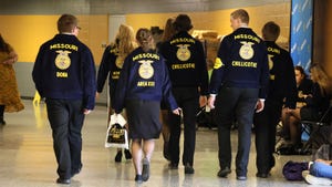 A group of FFA members walking down a hallway