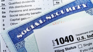  A Social Security card rests in between the pages of a 1040 tax form