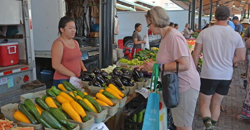 Vendors and shoppers at a farmers market