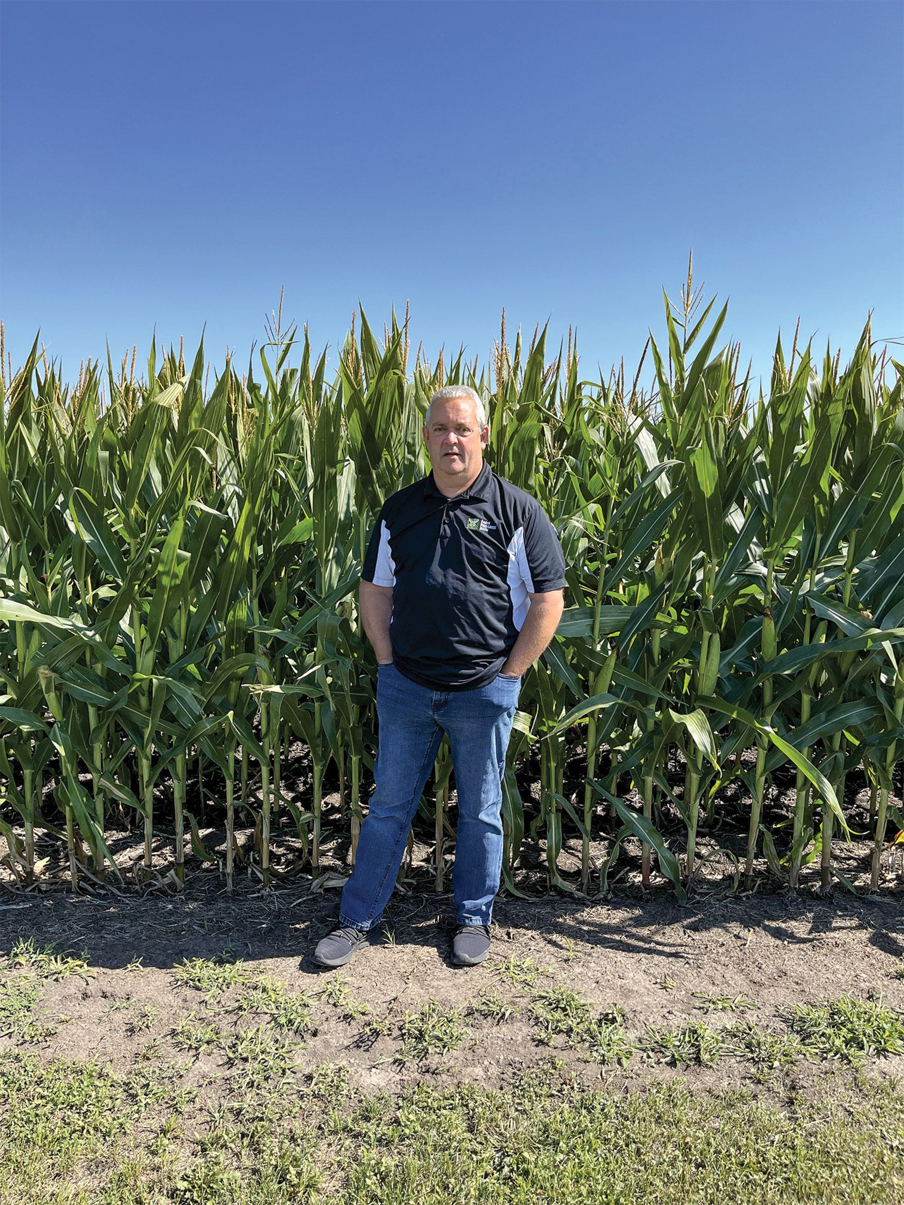 Rick Wild stands in front of a cornfield