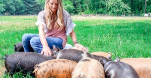Amanda Hand of MKONO Farm in Huntingtown, Md., in a field with her Kunekune pigs