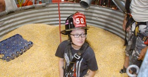 Volunteer firefighter Makayla Parson helps demonstrate how the grain bin rescue tube works 
